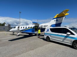 Ambulance plane parked in front of an ambulance can at Gardermoen airport