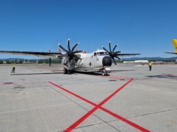 Propel plane parked outside in the summer. Red lines on the asphalt.